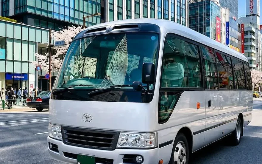 Silver Toyota Coaster micro bus for group tours in Ginza, Tokyo